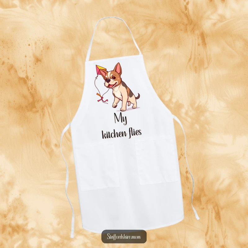 Funny determined Staffordshire dog apron, carrying a large colorful kite, humorous kitchen wear.