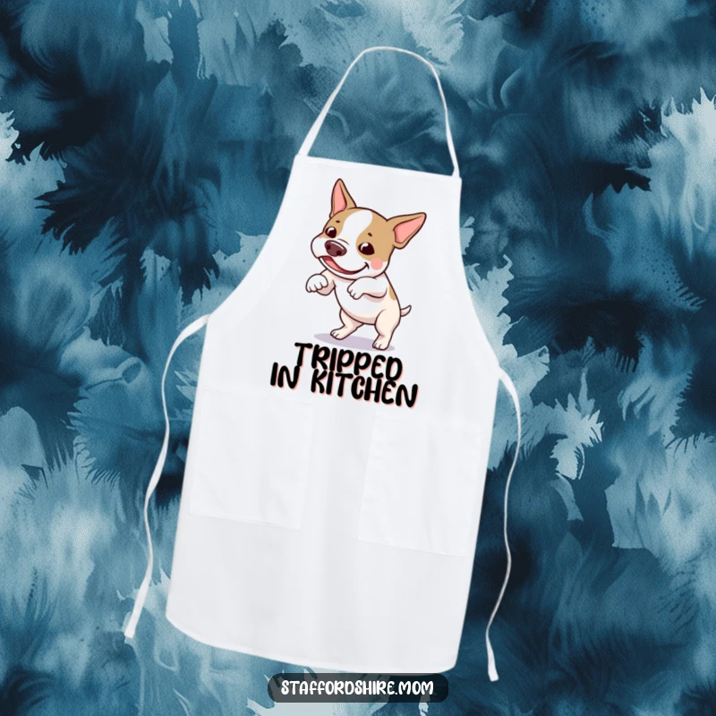 Funny Staffordshire bull terrier apron showing a dog amusingly tripping over its feet while cooking with a cheerful expression.