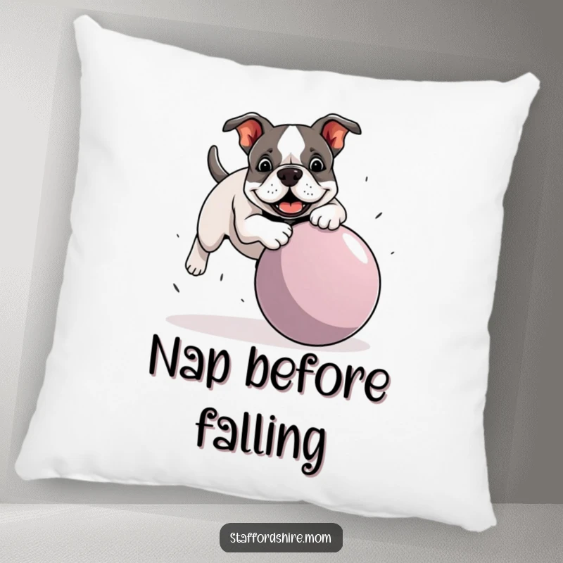 Funny Staffordshire Bull Terrier pillow showing a dog playfully tripping over a giant ball, offering comfort and a dose of humor.