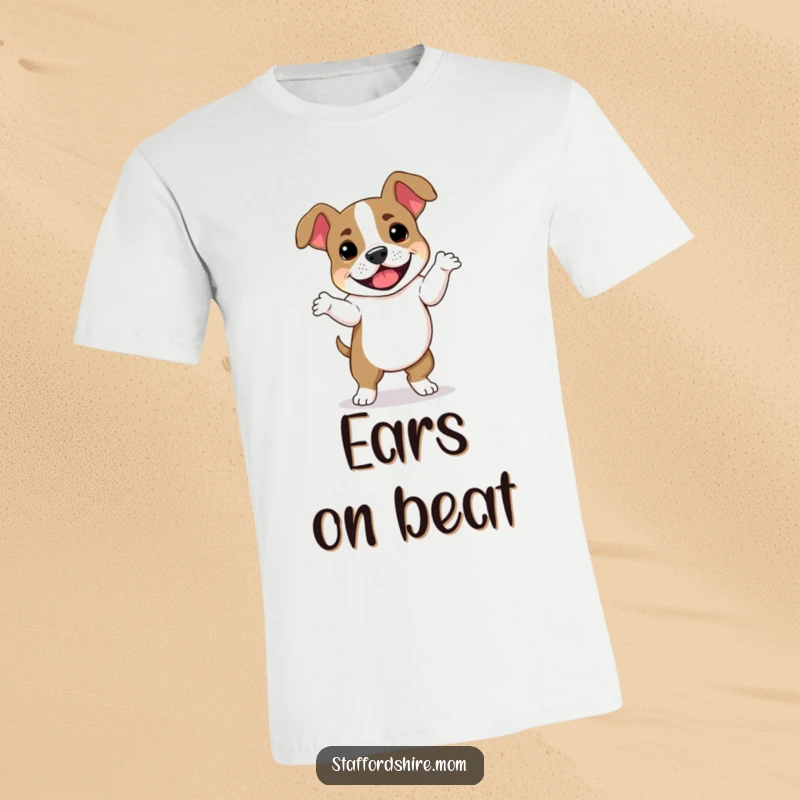 Funny Staffordshire Bull Terrier t-shirt showing a joyful dog in a silly dance pose with its ears flopping wildly, radiating pure happiness.