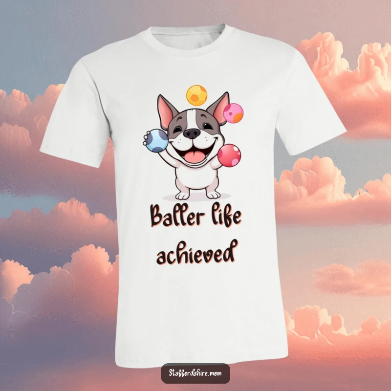 Funny Staffy bull terrier t-shirt with a happy dog grinning while trying to juggle three colorful balls.