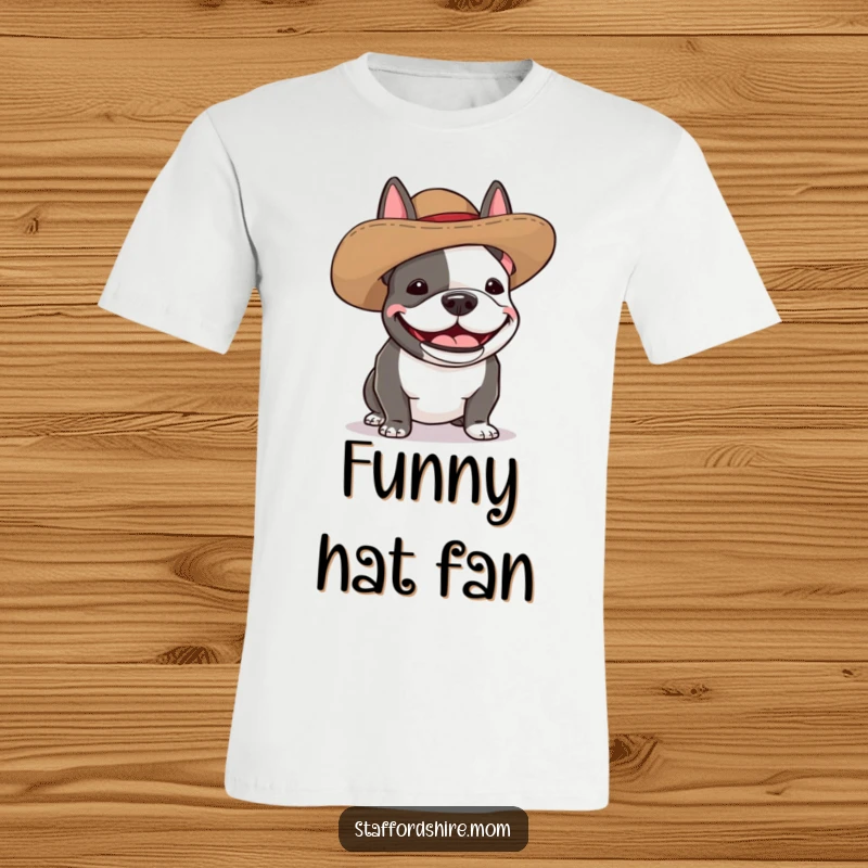 Funny Staffordshire bull terrier t-shirt featuring a dog wearing a comically oversized hat and giggling with pure amusement.