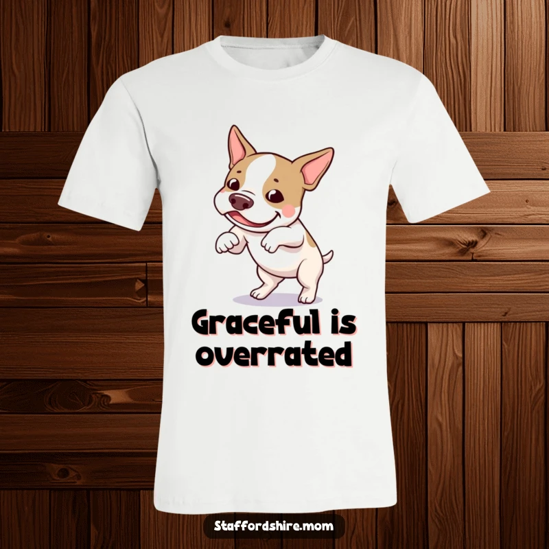 Funny Staffordshire bull terrier t-shirt of a dog amusingly tripping over its own feet, radiating playful charm.