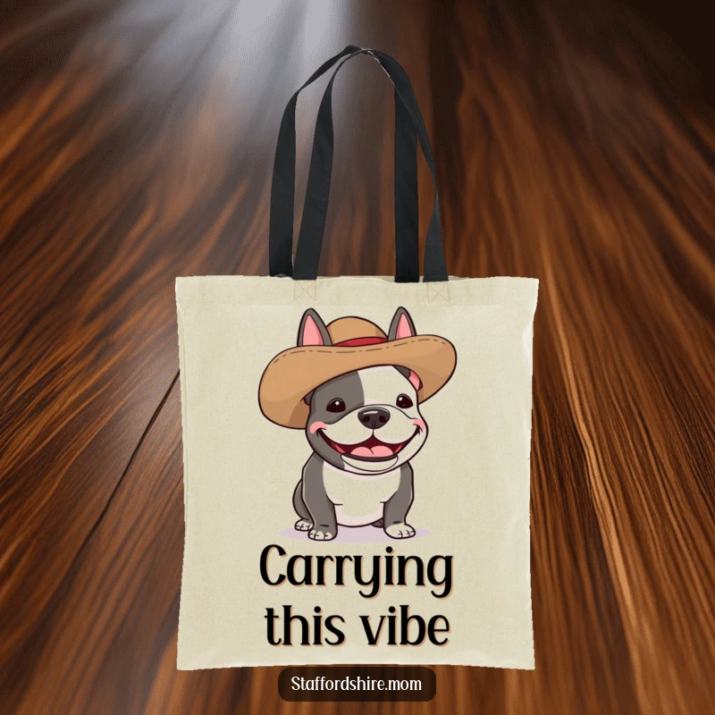 Funny Staffordshire bull terrier tote bag depicting a dog wearing a silly, oversized hat and giggling with pure delight.